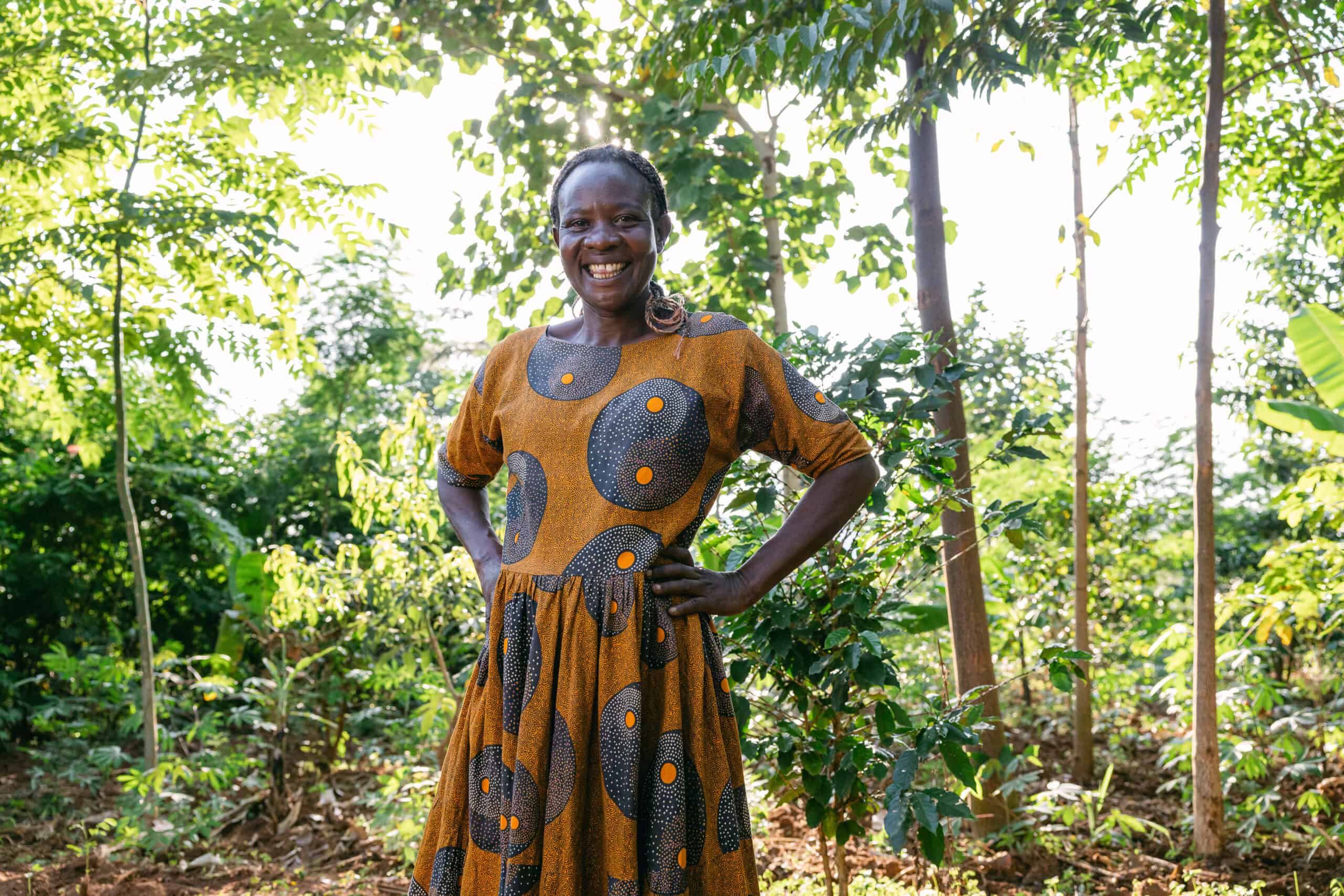 Forest Garden farmer Harriet in her Forest Garden, along coffee plants.